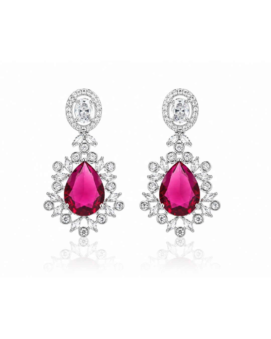 Pair of earrings with red gemstones and silver accents on a white background