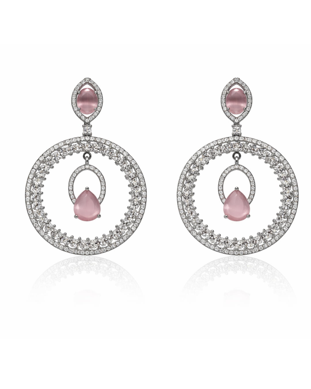 Pair of earrings with pink gemstones and circular designs on a white background