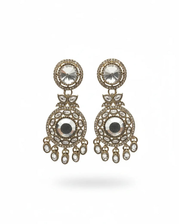 Pair of ornate earrings with gemstones on a white background