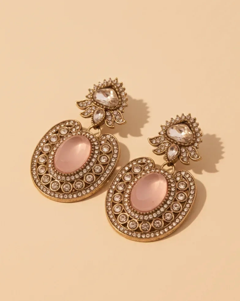 Capture the charm of a bygone era with our Victorian-style drop earrings. These stunning statement pieces pair a warm, aged-gold finish with soft pink stones and brilliant crystal accents.