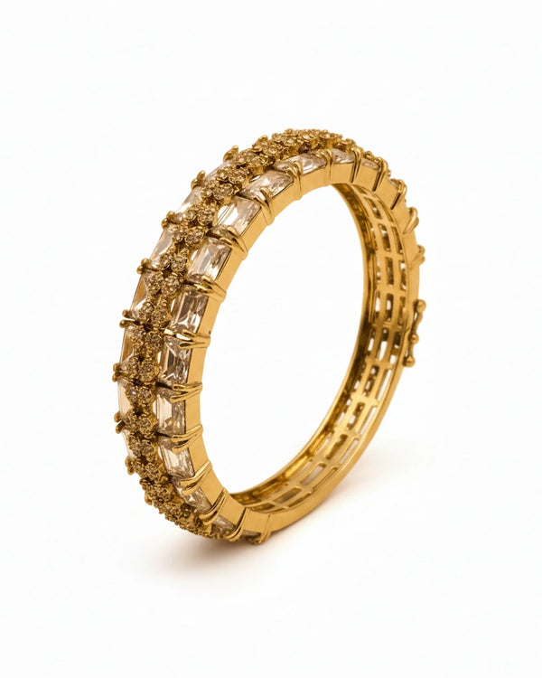 Gold ring with diamond accents on a white background