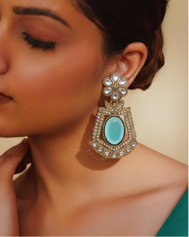Close-up of a woman wearing a decorative earring with a turquoise stone.