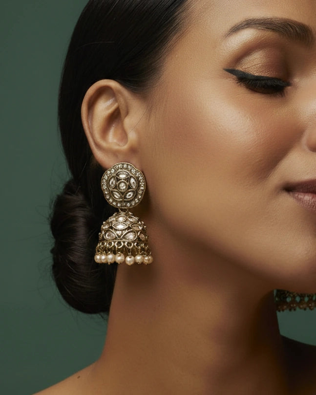 Close-up of a woman wearing ornate earrings with a dark background
