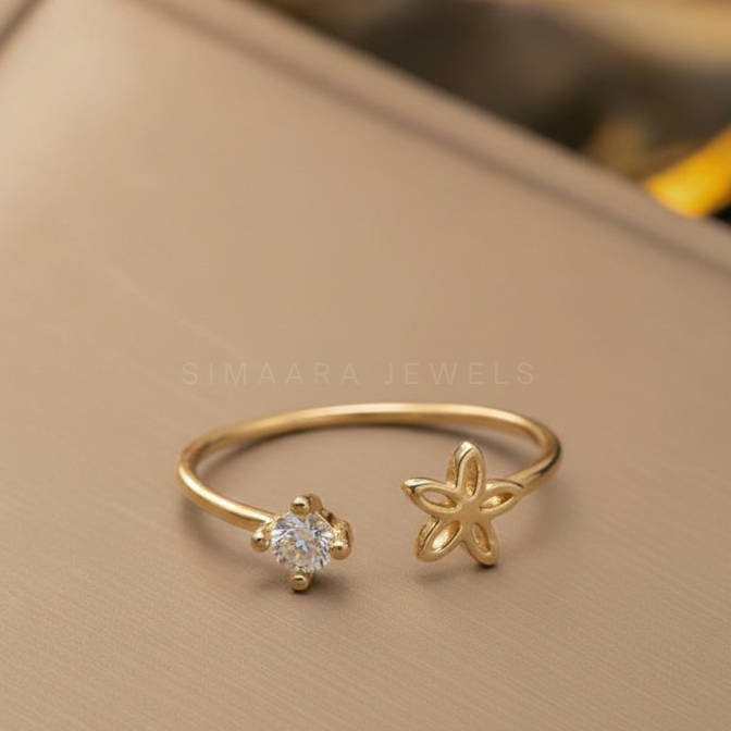 Gold ring with diamond and floral design on a beige background, branded 'Simaara Jewels'.