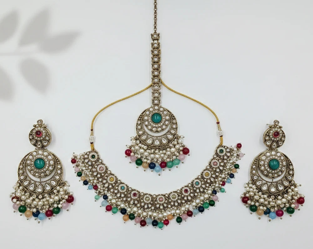 Ornate necklace with matching earrings on a light background