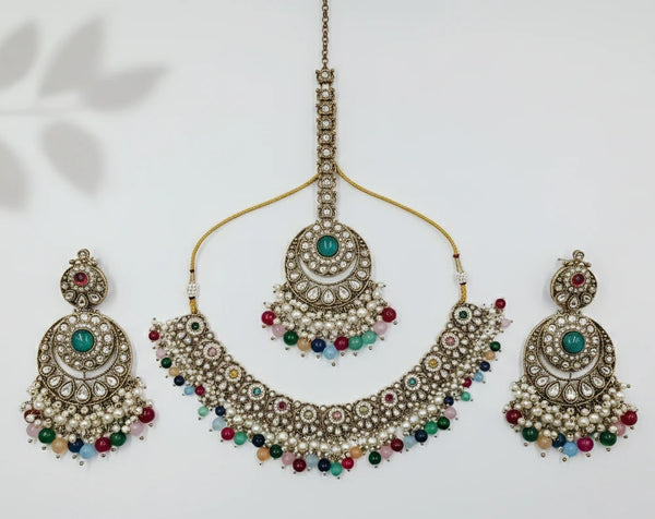 Ornate necklace with matching earrings on a light background