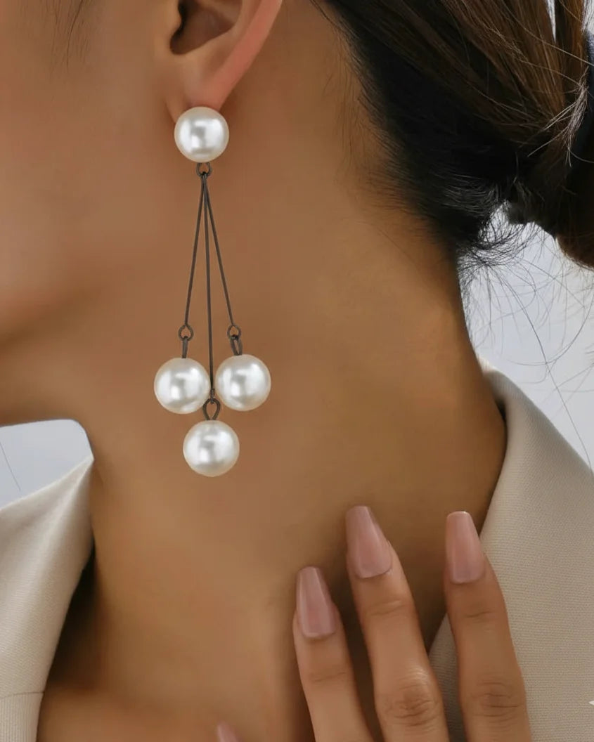 Pearl earring worn by a person with a neutral background