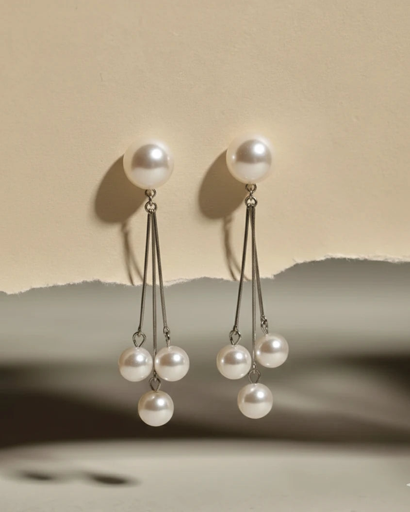 Pearl earrings with a beige background