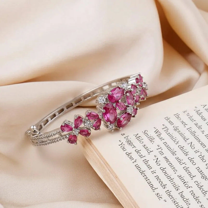 Bracelet with pink gemstones on a book with text