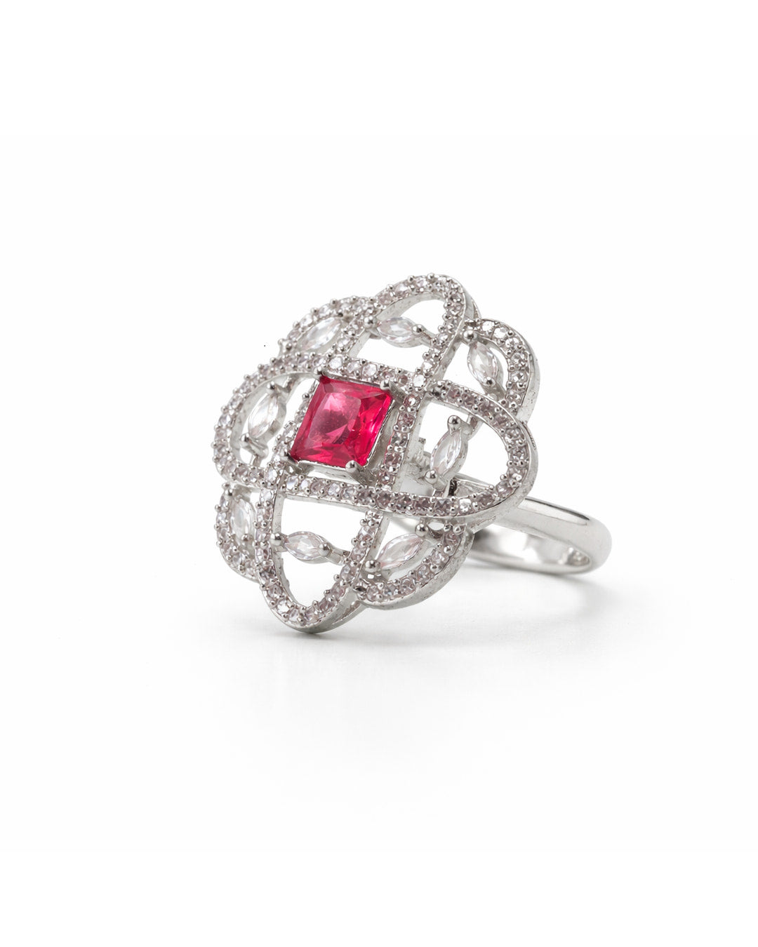 Silver ring with a red gemstone on a white background