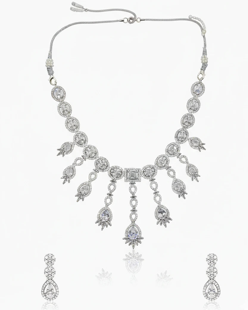 Silver necklace with teardrop-shaped pendants on a white background