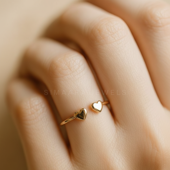 Gold heart-shaped ring on a hand with 'Simaara Jewels' branding.