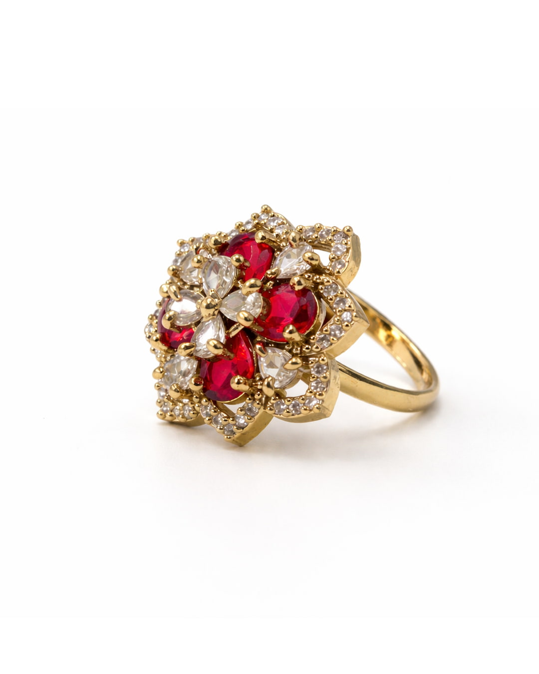 Gold ring with red gemstones and clear stones on a white background