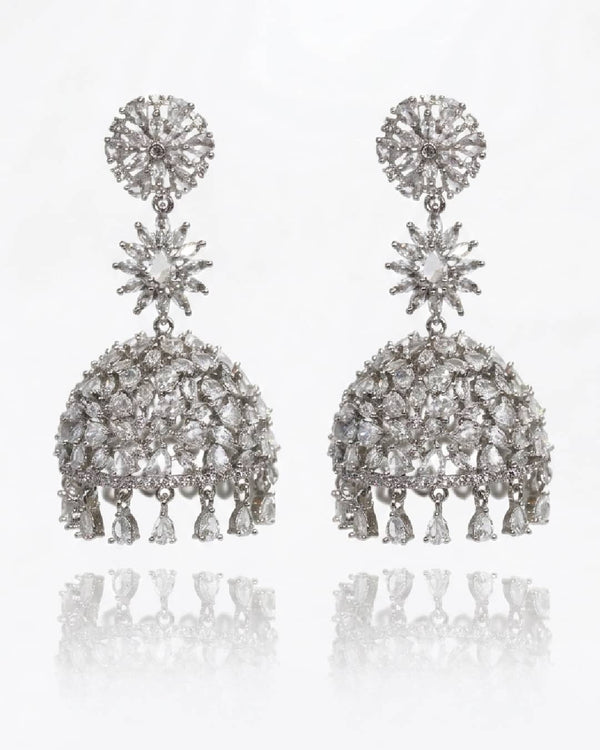 Pair of silver earrings with clear stones on a white background