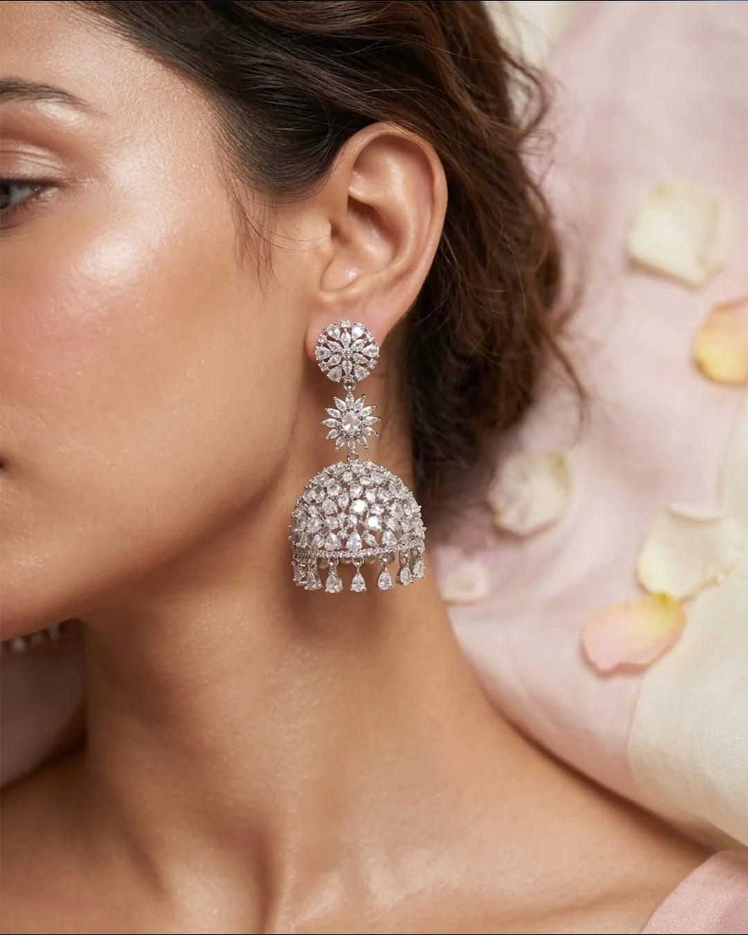 Close-up of a woman wearing silver earrings with a soft background
