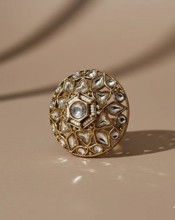Decorative ring with intricate design on a beige background