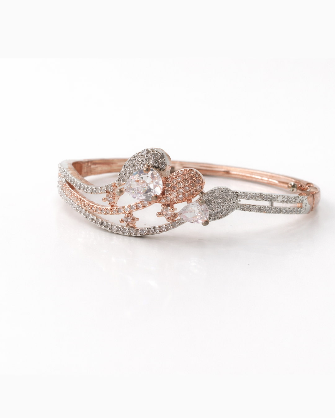 Rose gold ring with heart-shaped gemstone on a white background