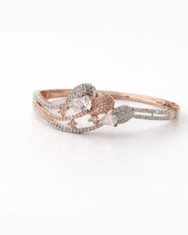 Rose gold ring with heart-shaped gemstone on a white background