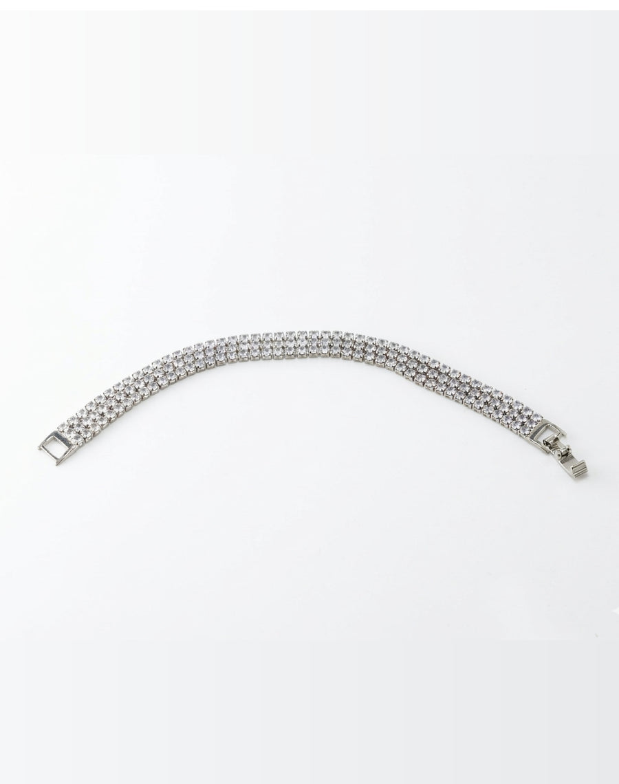 Silver bracelet with clear stones on a white background