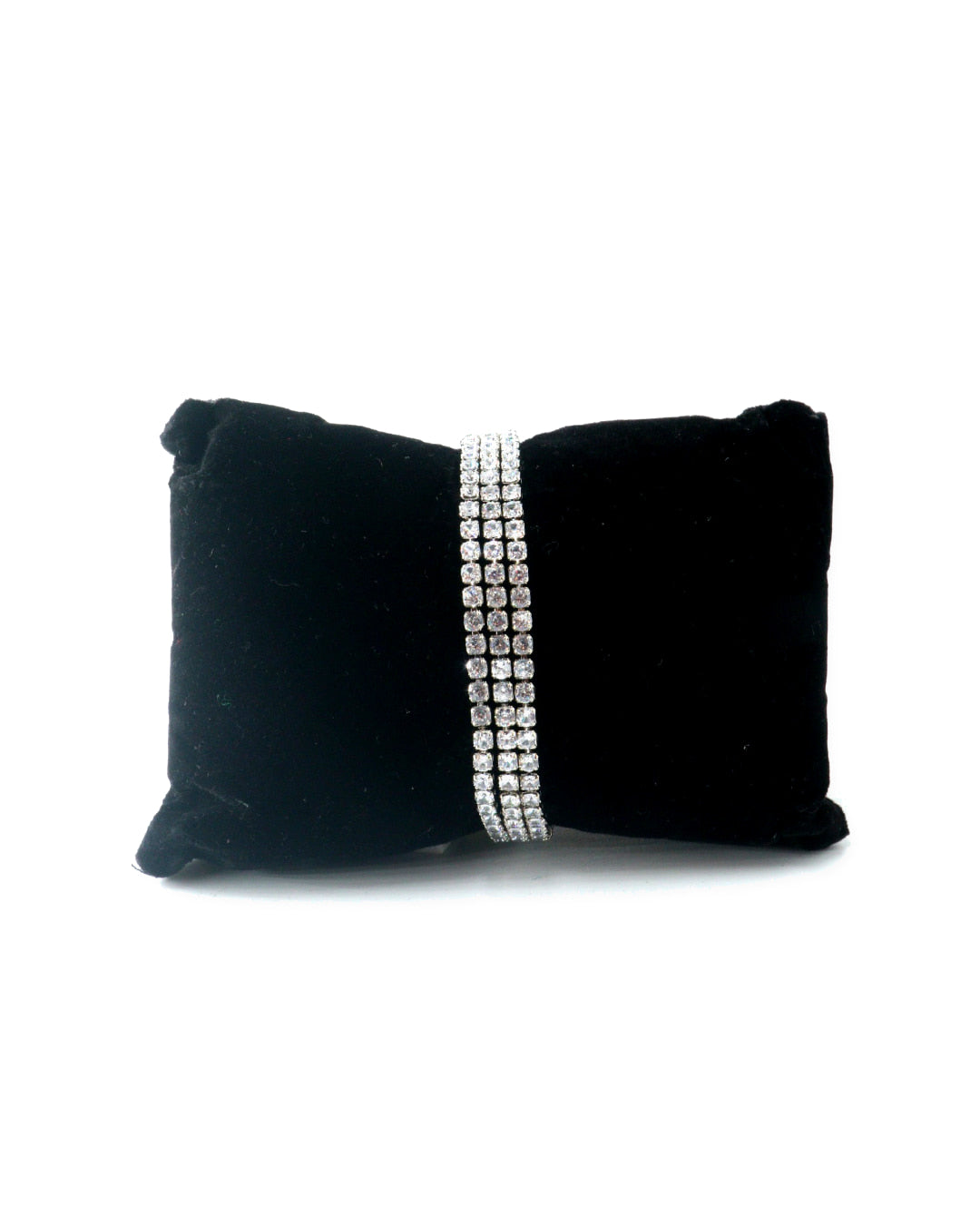 Silver bracelet with clear stones on a white background
