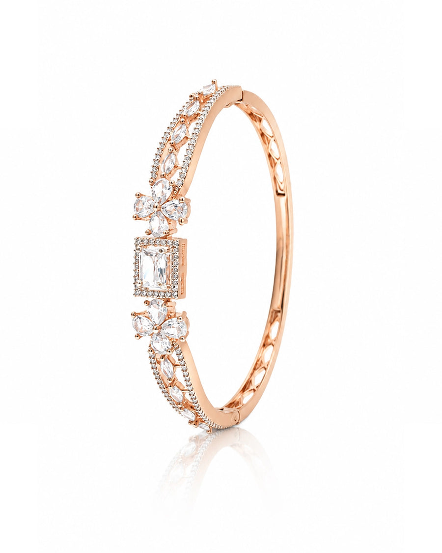 Rose gold bracelet with diamond accents on a white background