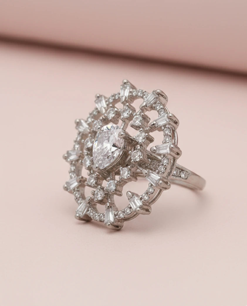 ring with a heart-shaped center stone on a pink background