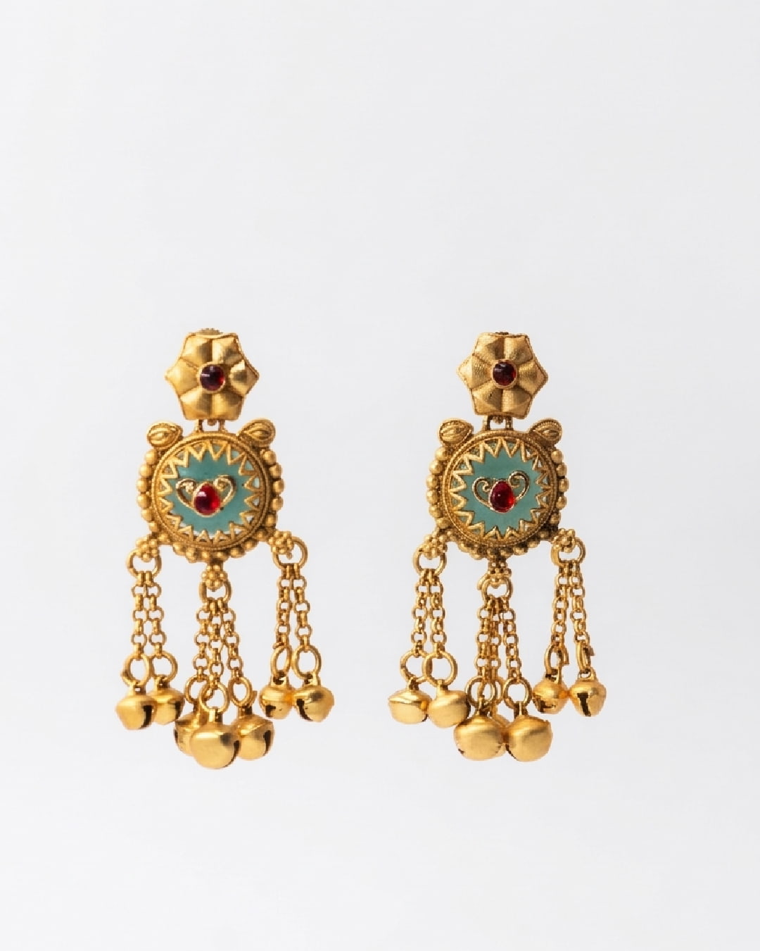 Pair of golden earrings with blue circular designs and red stones on a white background