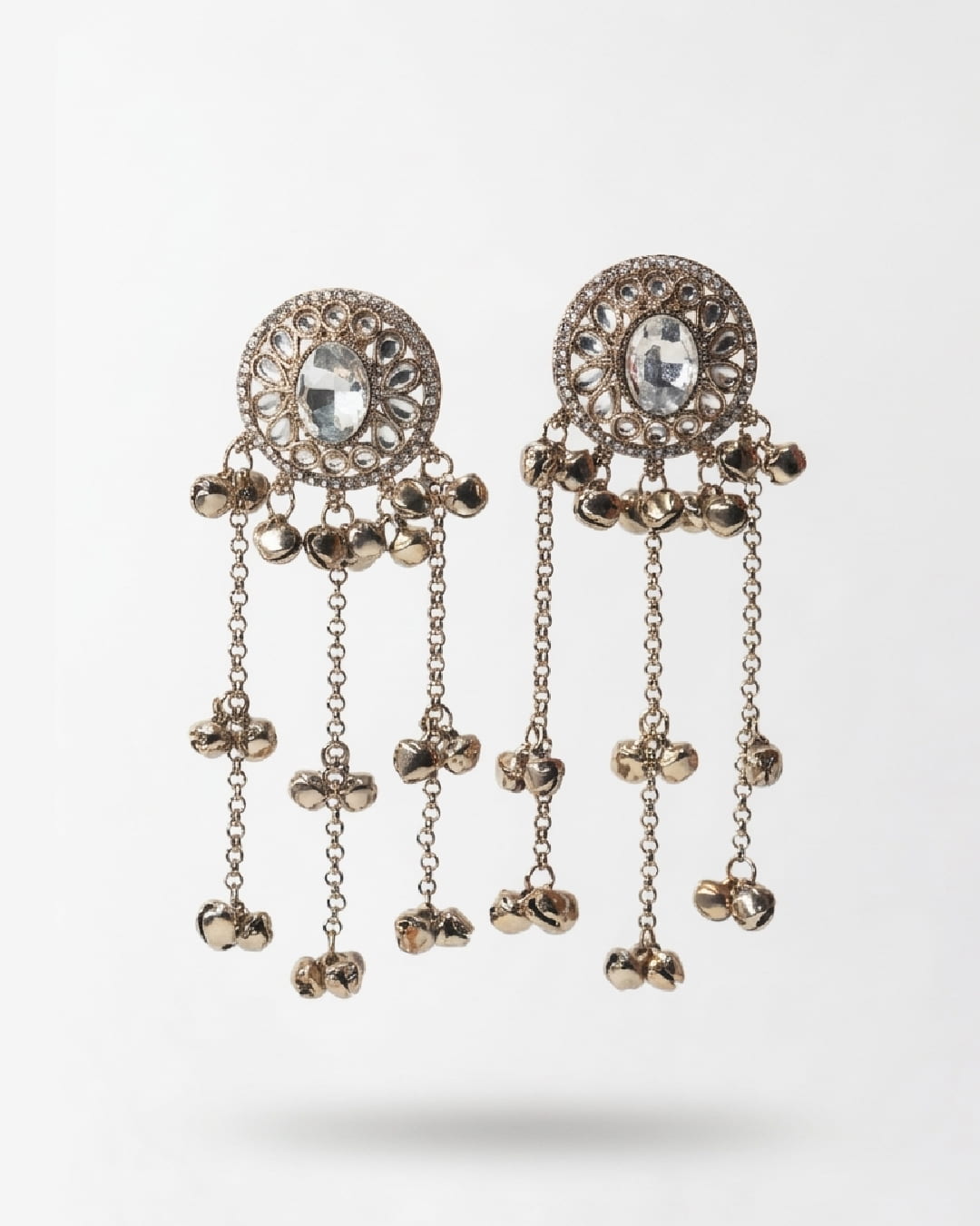 Decorative earrings with chains and gemstones on a white background