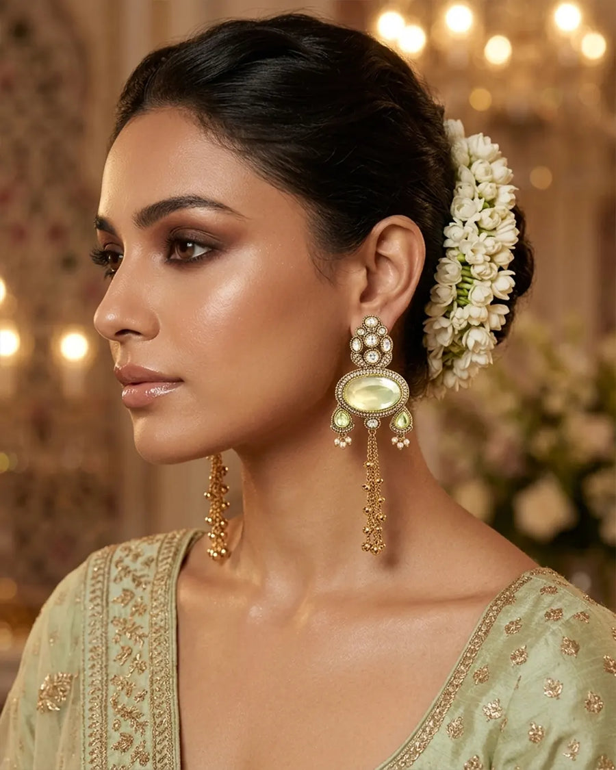 Woman wearing traditional earrings and a headpiece with a blurred background