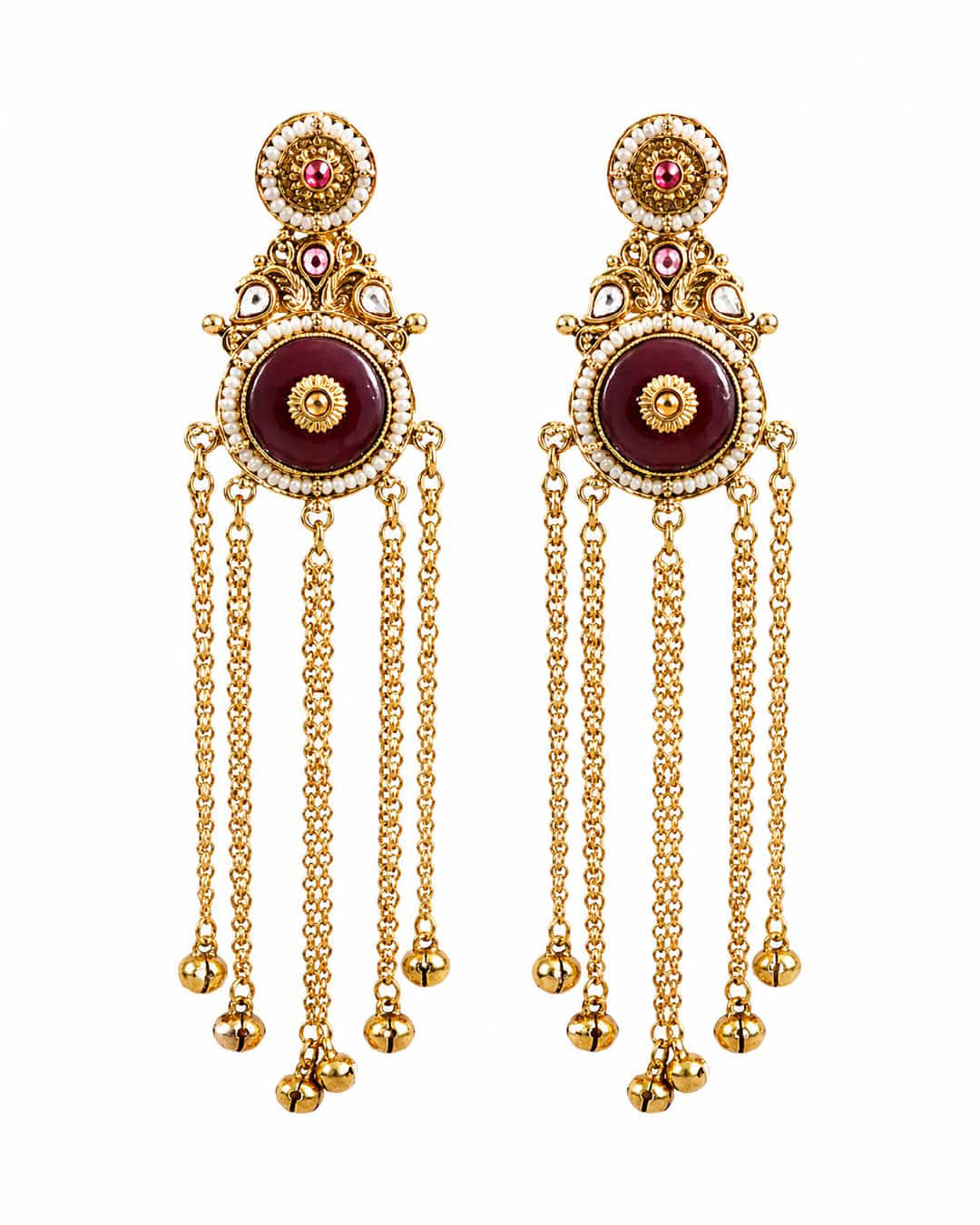 Ornate gold earrings with maroon centers and dangling chains on a white background