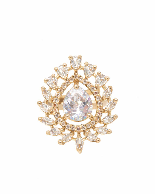 Gold brooch with a central teardrop-shaped gemstone on a white background