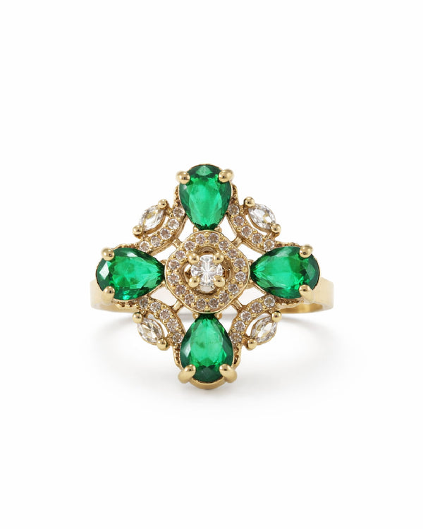 Gold ring with emerald and diamond stones on a white background