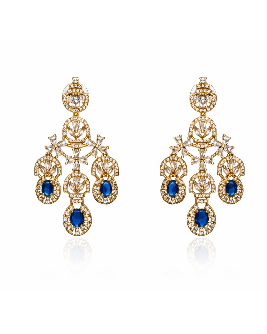 Gold earrings with blue gemstones on a white background